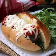 Meatball sub on a square white plate.