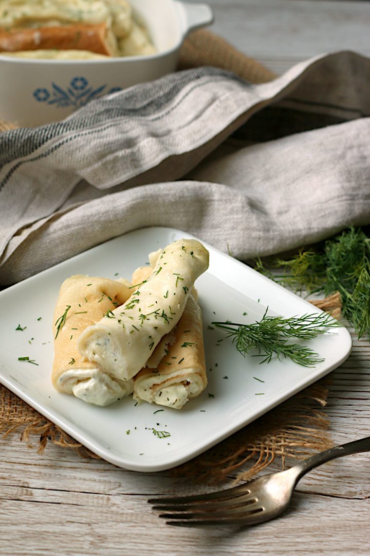 Domestic Dreamboat: Real, Easy, Food. Nalysnyky (Savory Ukrainian Crepes with Dill and Cottage Cheese) on a small, square, white plate.