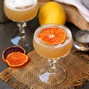 Non Alcoholic Whisky Sour in a crystal coupe garnished with a dried orange slice