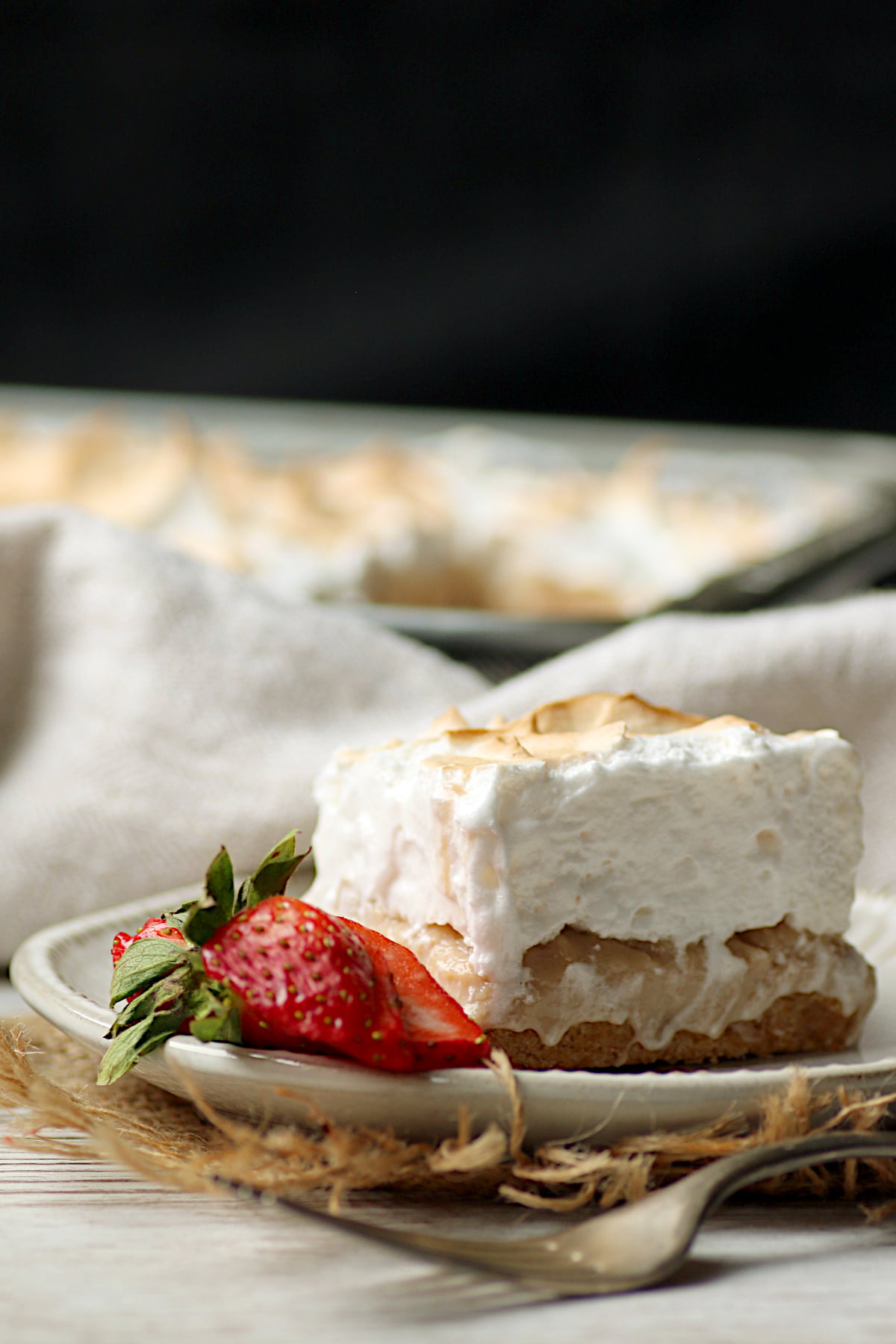 A Strawberry Rhubarb Curd Square topped with Italian Meringue.