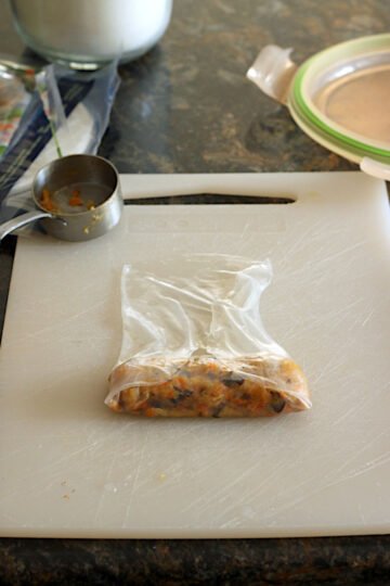 A spring roll wrapper with the bottom and sides folded over the filling.