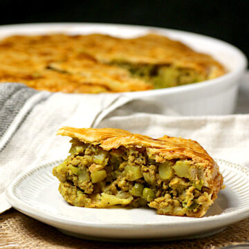 A slice of Chicken Samosa Pie on a small white plate.