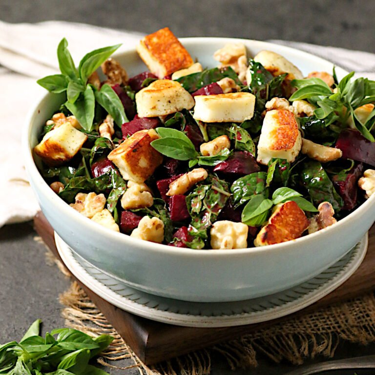 Kale Salad with Beets and Halloumi in a pale blue bowl.