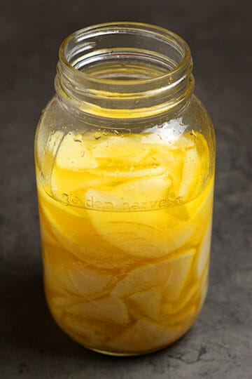 2lbs sliced, salted daikon in a jar covered with brine.