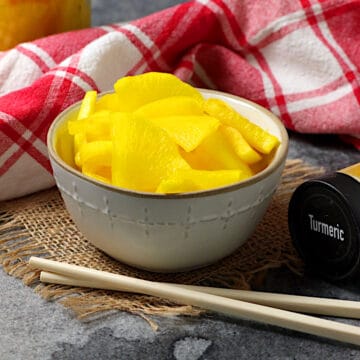 Yellow Japanese Pickled Daikon in a small white bowl.