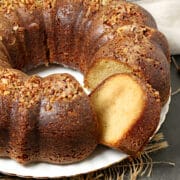 A whole Caribbean Rum Cake with a slice removed.