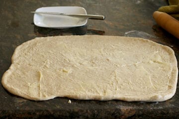Rectangle of dough spread with softened butter.
