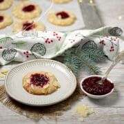 Cherry Almond Thumbprint Cookie on a small white plate.