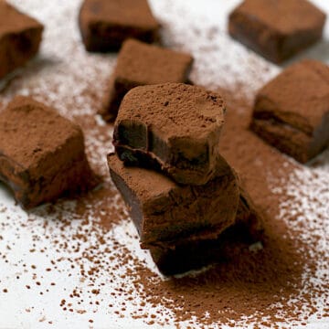 A stack of Nama Chocolate covered in cocoa powder.