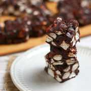 A stack of Chocolate Cherry Marshmallow Squares on a small white plate.