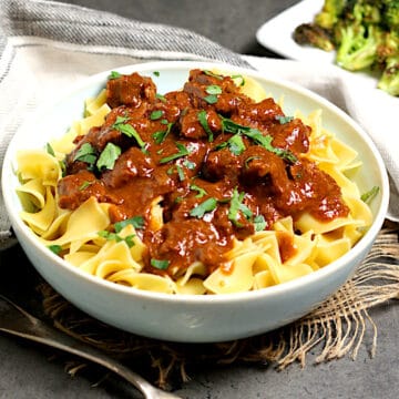 Beef Paprika and egg noodles in a pale blue bowl.