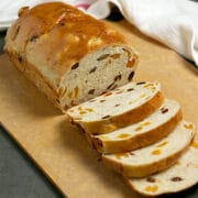A partially sliced loaf of Apricot Raisin Bread