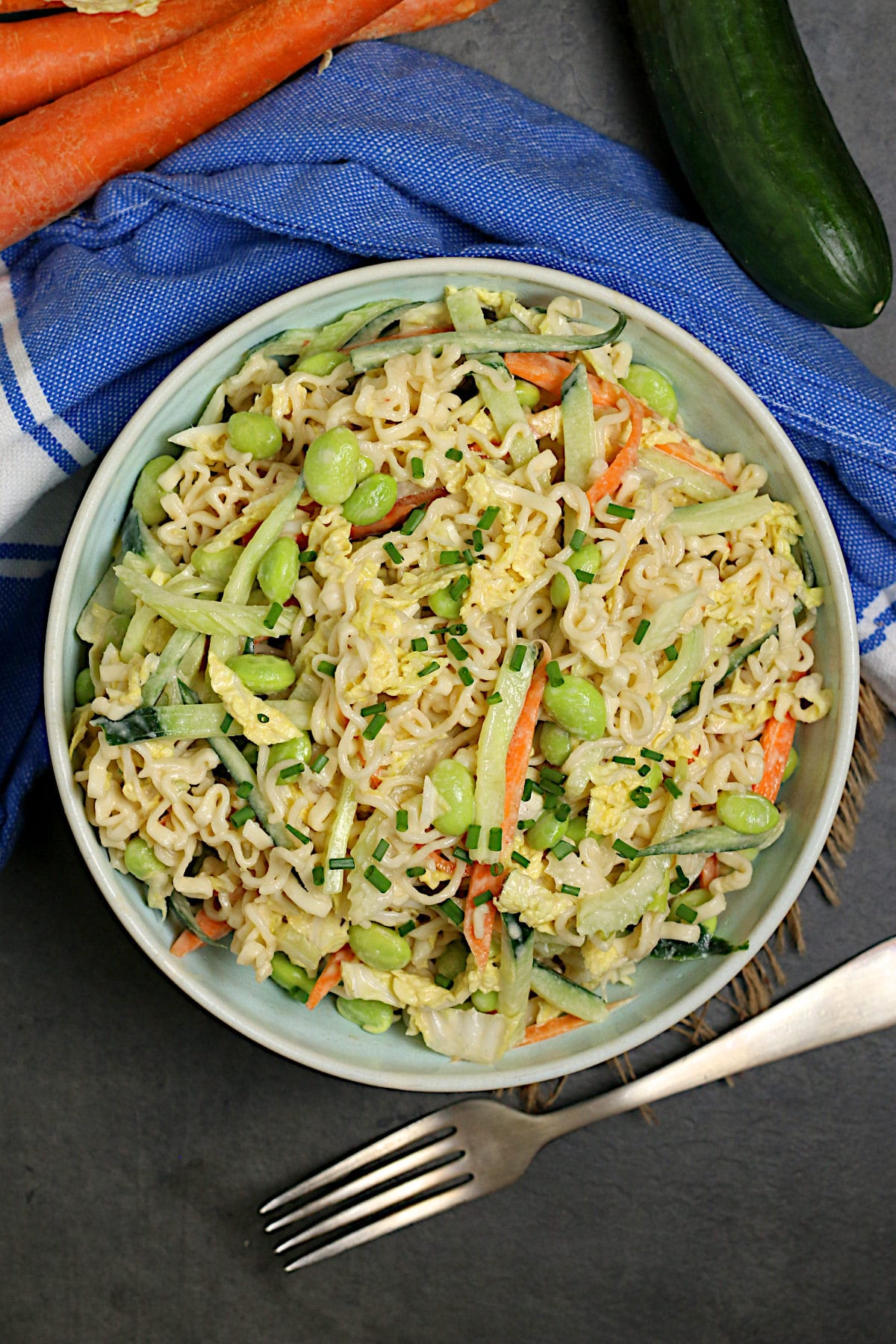 An overhead photo of Noodle Salad with Tahini Dressing in a pale blue bowl.