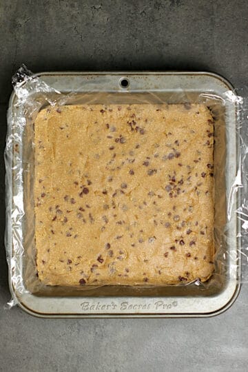 Oatmeal Chocolate Chip Cookie Dough pressed into an 8x8" baking pan.