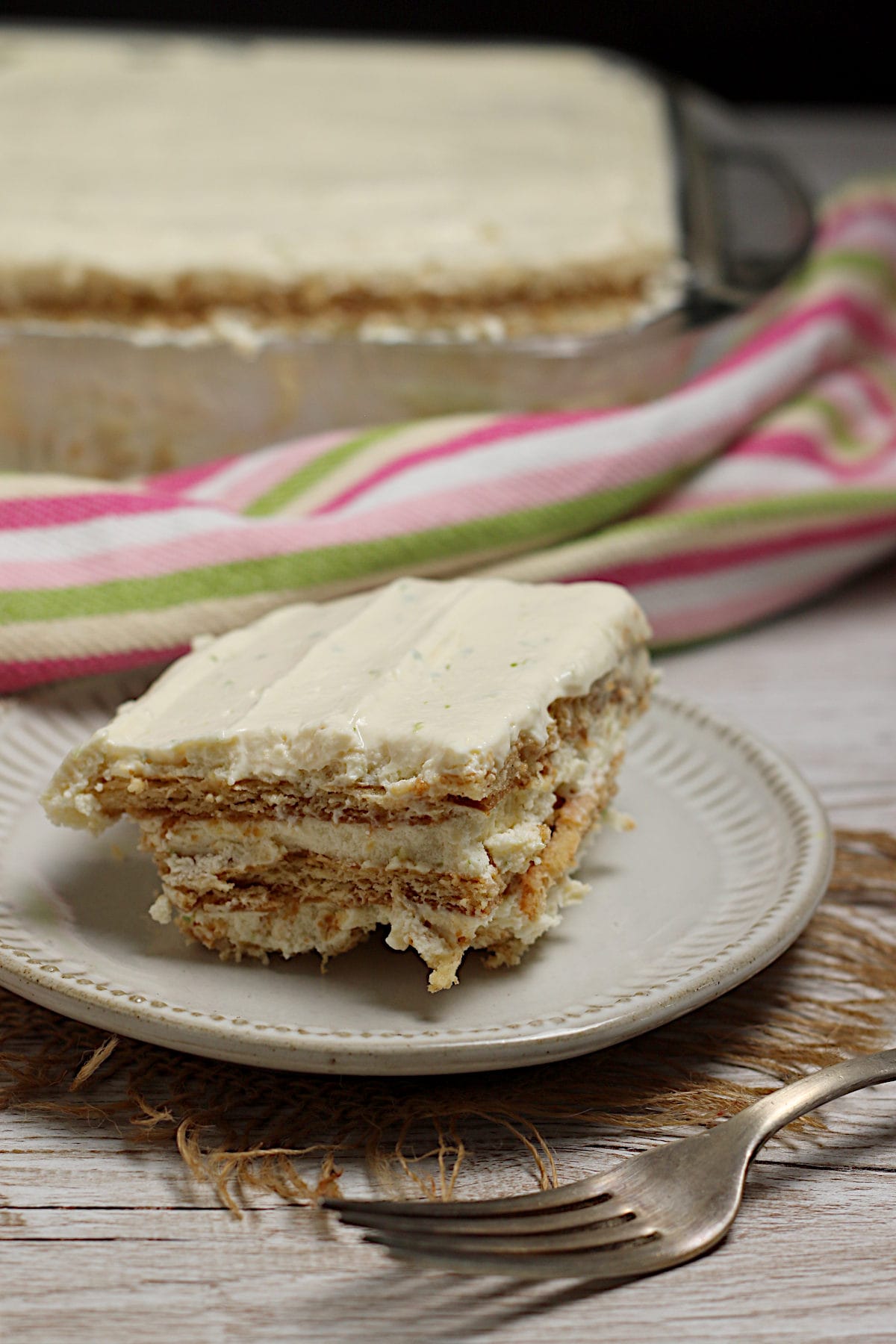 Easy 4 Ingredient Key Lime Icebox Cake A slice of Key Lime Icebox Cake on a small white plate.