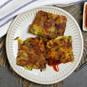 Korean Vegetable Pancake cut into squares on a small white plate.