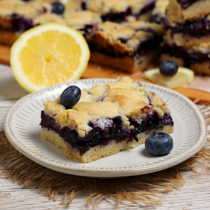 A Blueberry Cream Cheese Pie Bar on a small white plate.