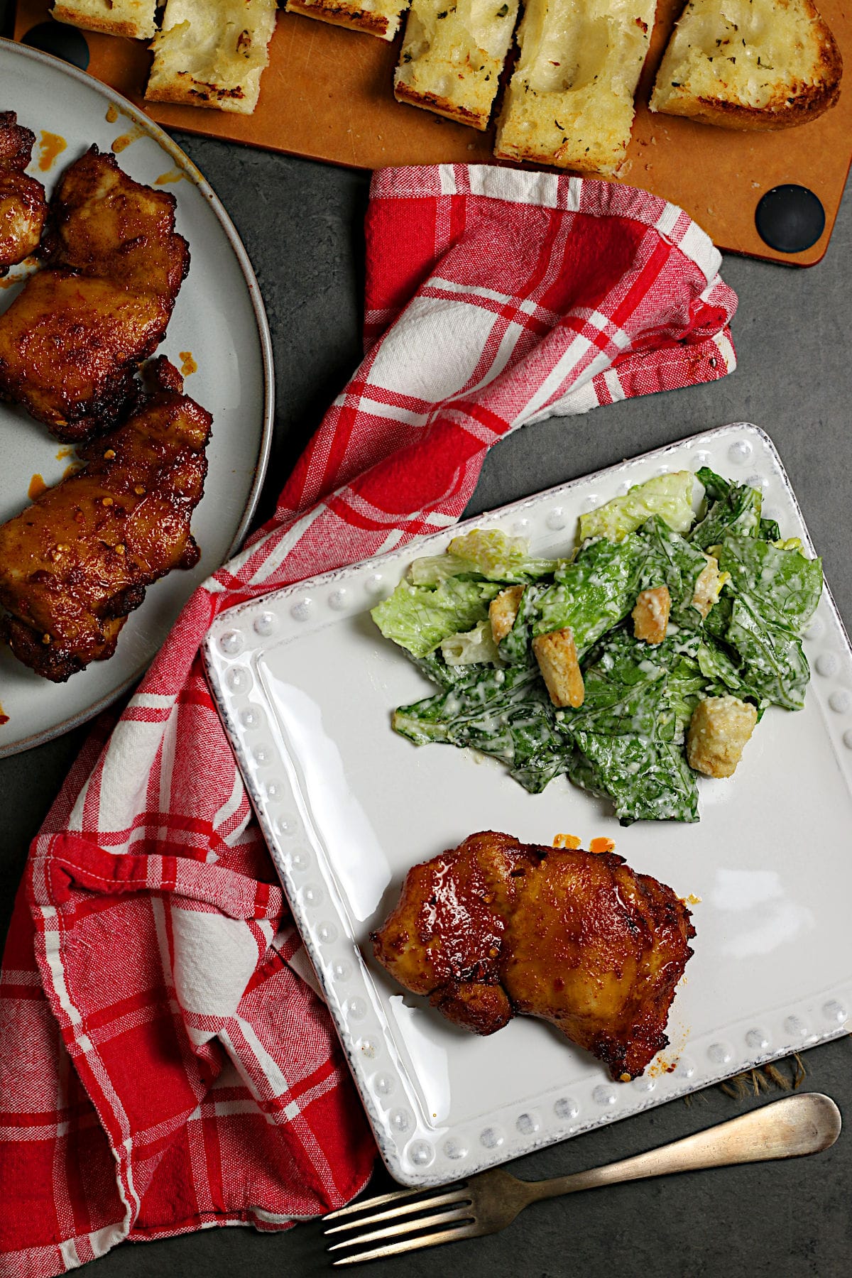 An overhead photo of a Hot Honey Glazed Chicken Thigh on a white plate.
