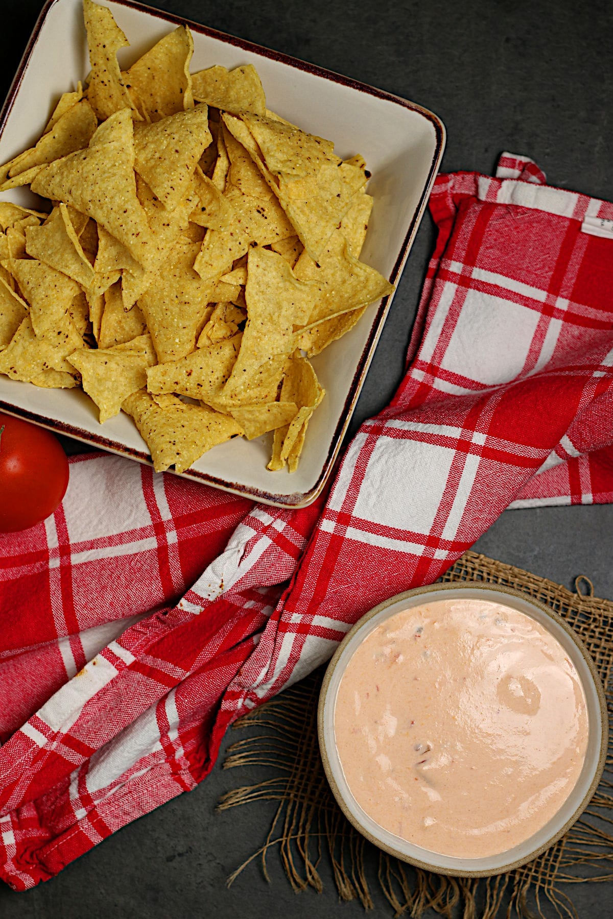 An overhead photo of a small bowl of cottage cheese queso and a bowl of tortilla chips.