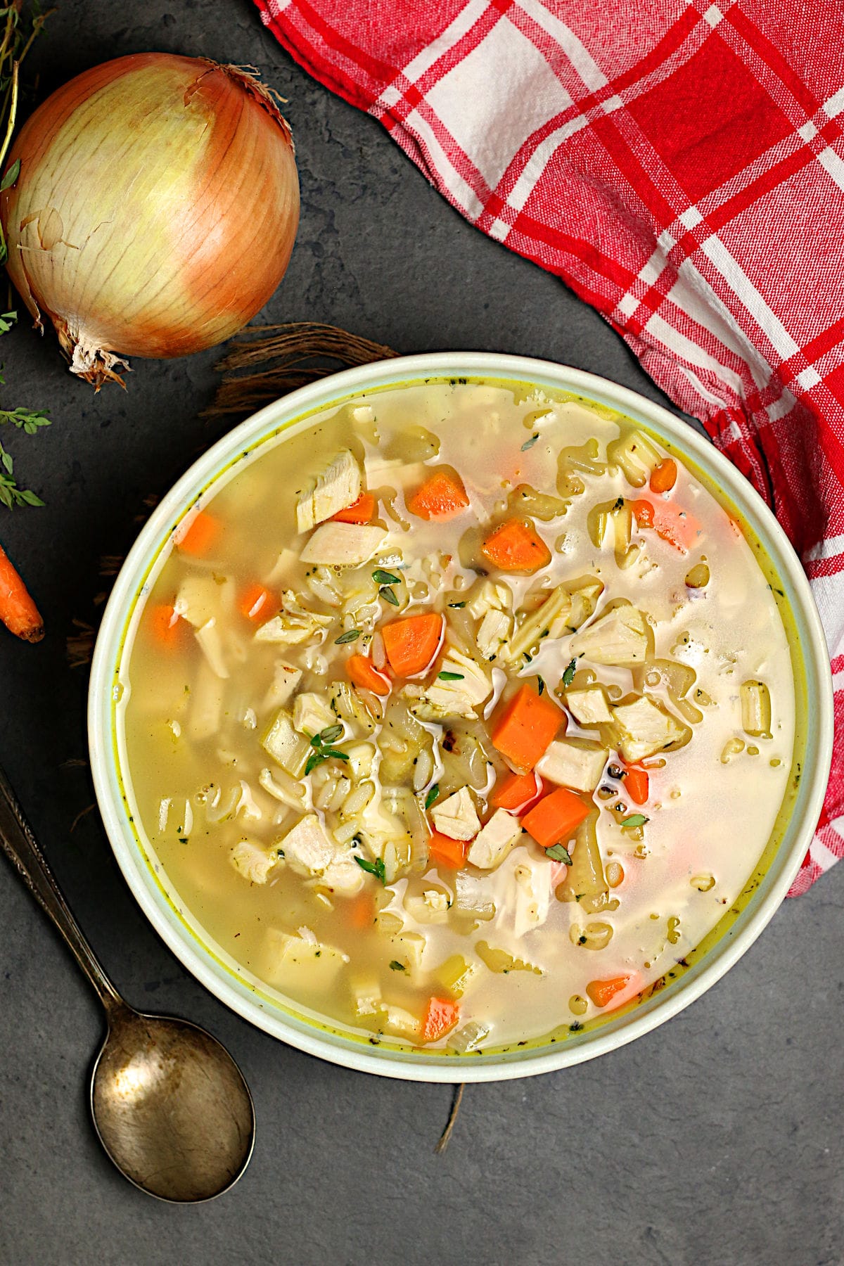 An overhead photo of homemade Turkey Rice Soup in a pale blue bowl.