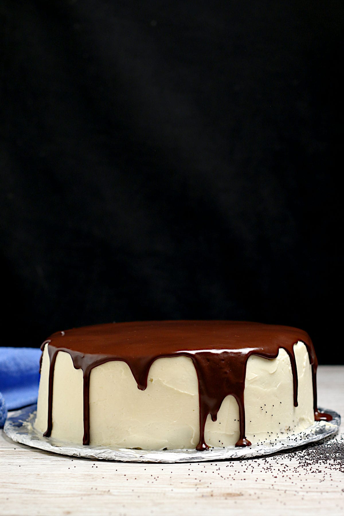 A whole Poppyseed Sponge Cake with vanilla buttercream and chocolate ganache.