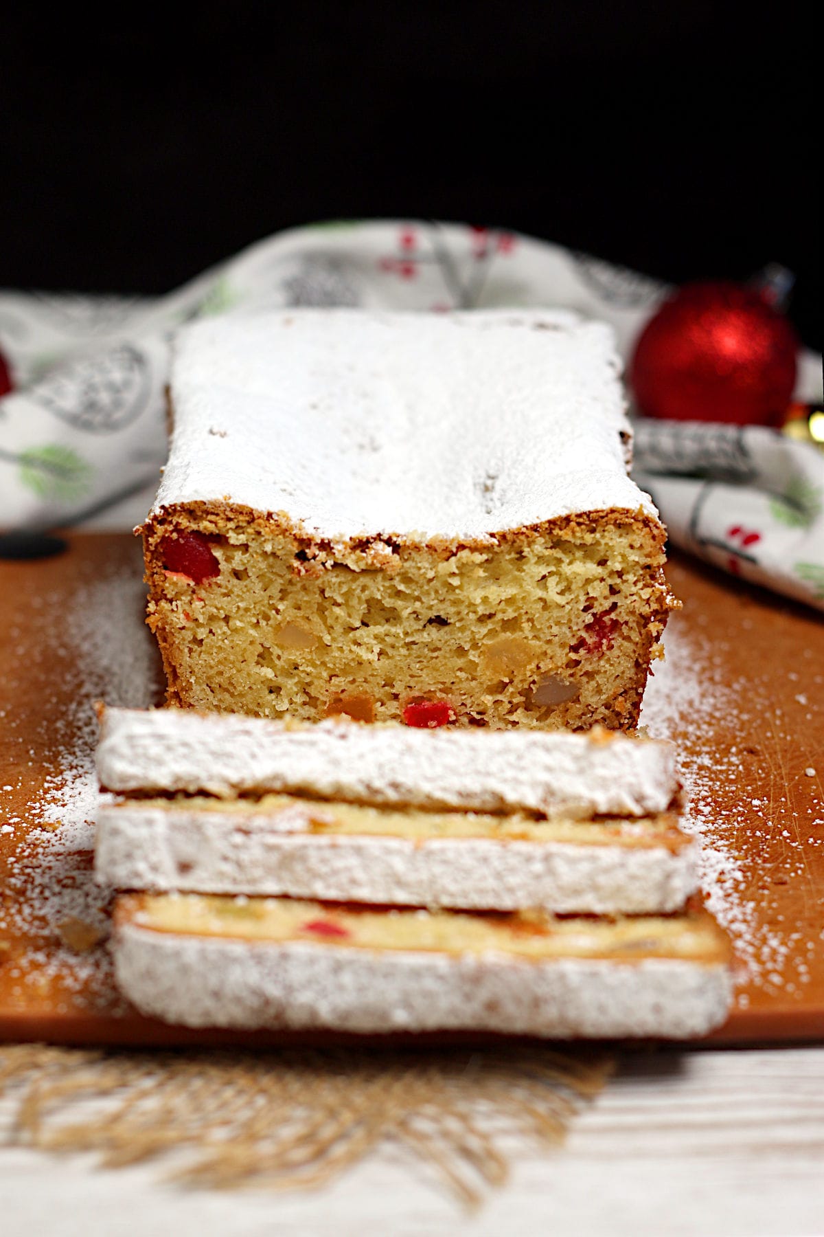 Gumdrop Loaf Cake A Gumdrop Loaf Cake topped with powdered sugar on a cutting board.