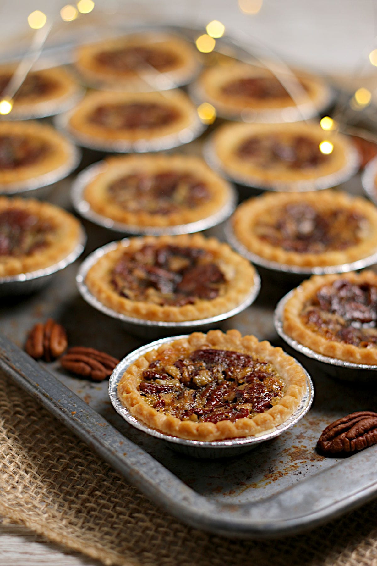 Maple Pecan Tarts Homemade Maple Pecan Tarts on a baking sheet.