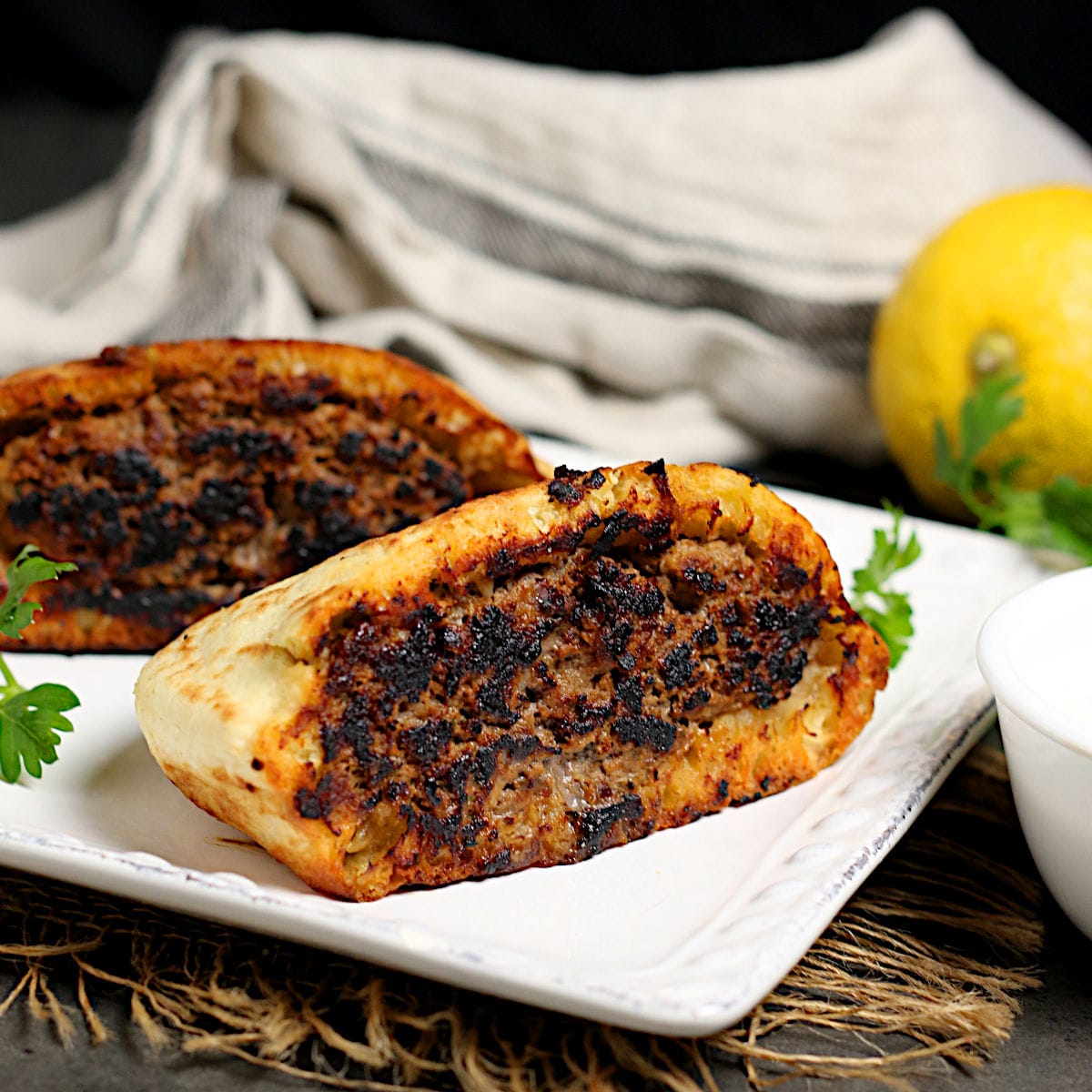 Arayes (Lebanese Beef-Stuffed Pitas) on a white plate.