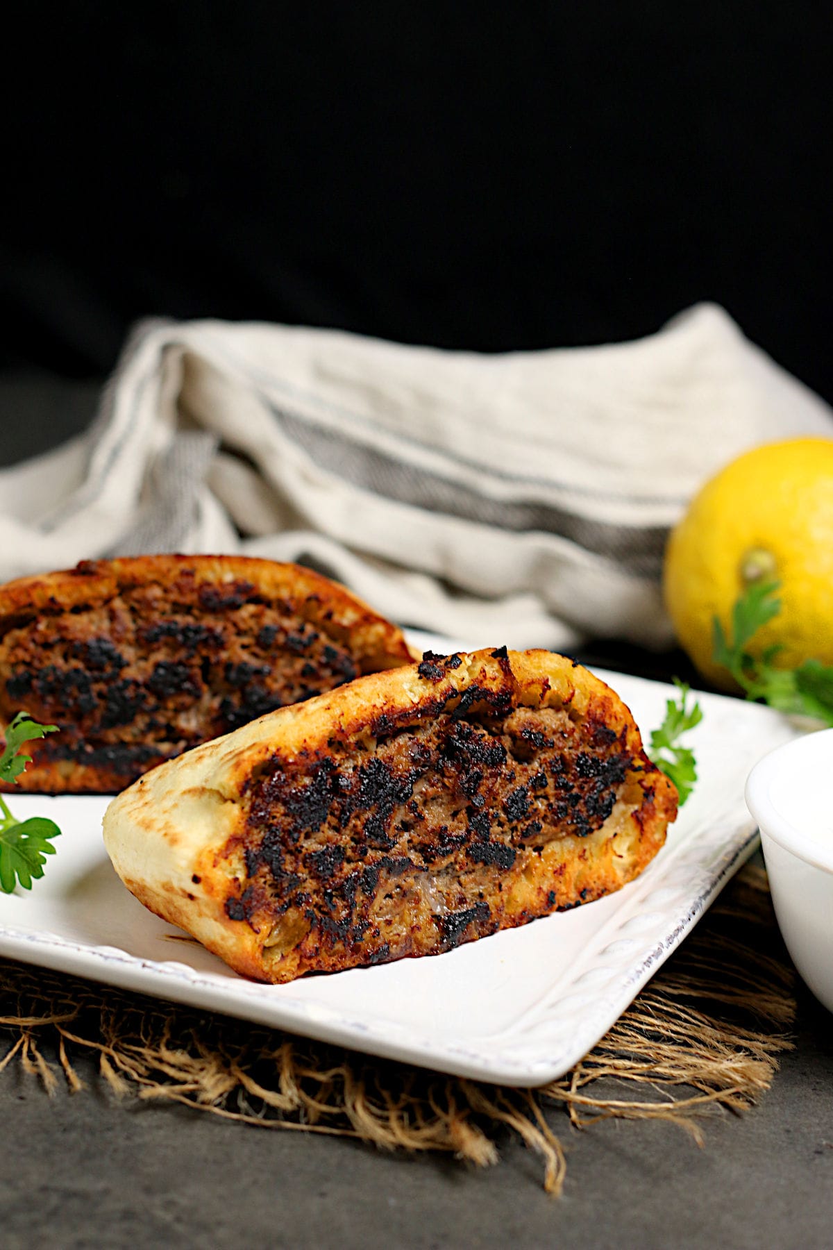 Arayes (Lebanese Beef-Stuffed Pitas) on a white plate.