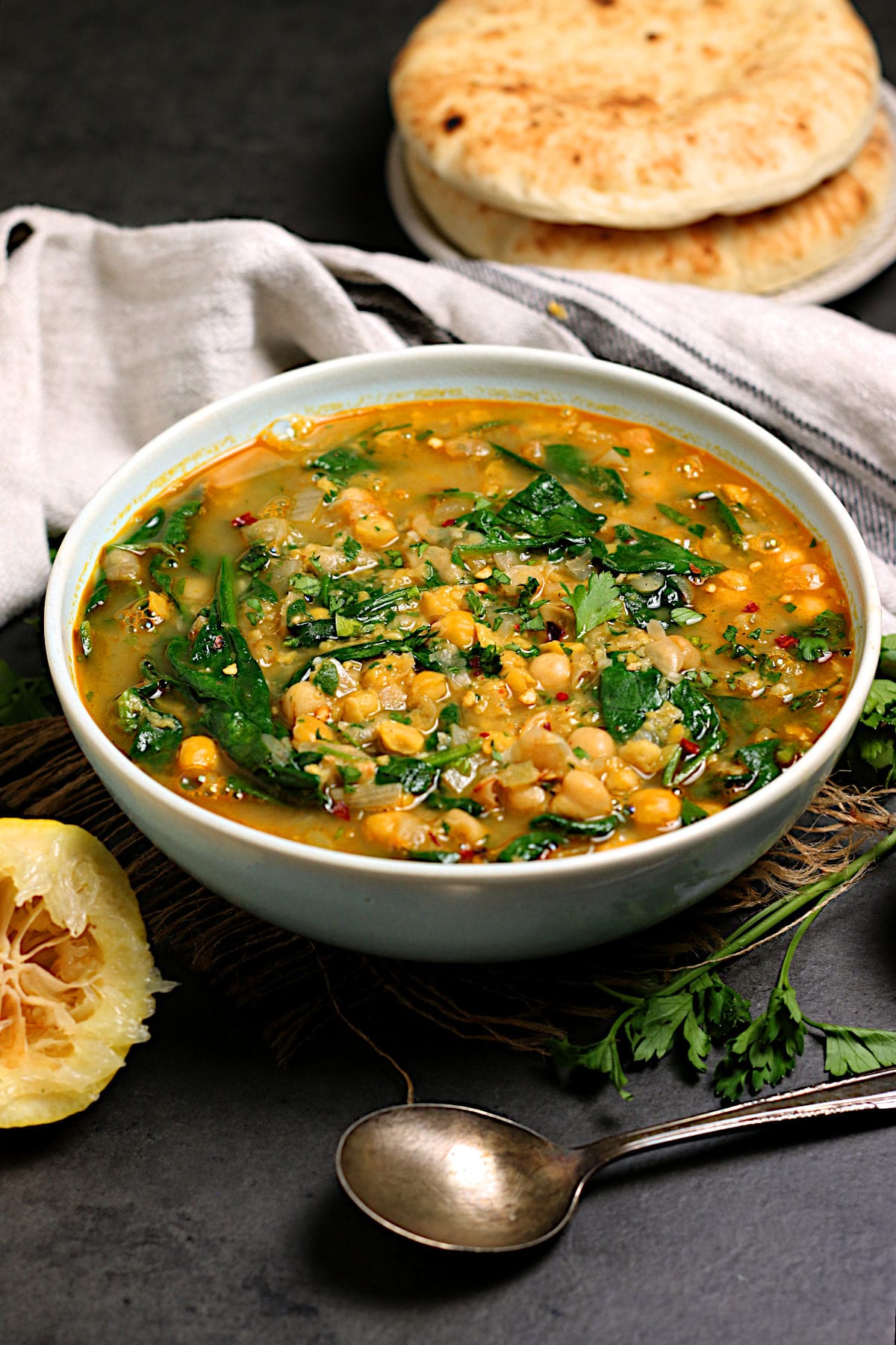 Chickpea Soup with Spinach and Garlic in a pale blue bowl.
