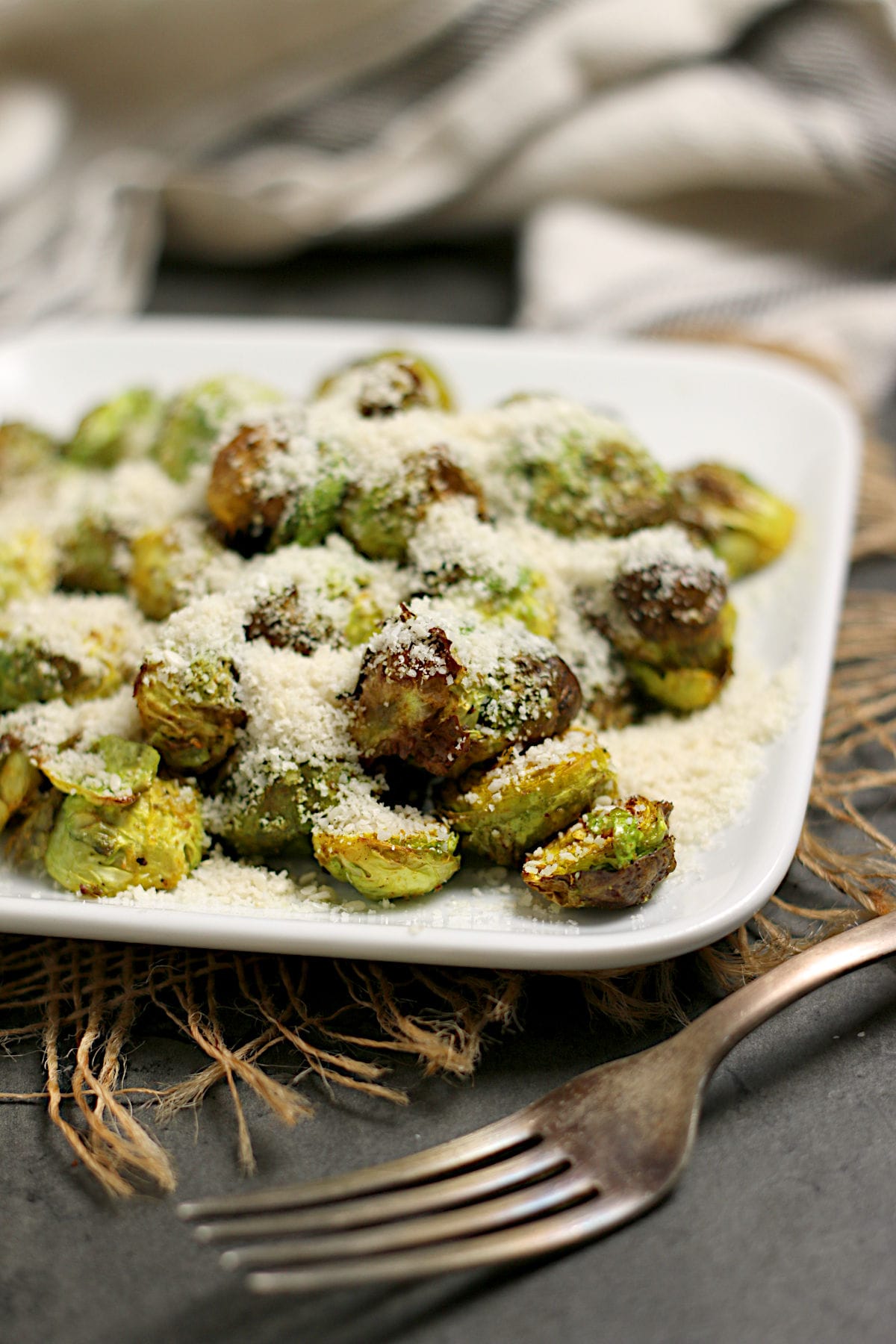 Crispy Brussels Sprouts with Curry and Sesame Powder Crispy Brussels Sprouts with Curry and Sesame Powder on a small white plate.
