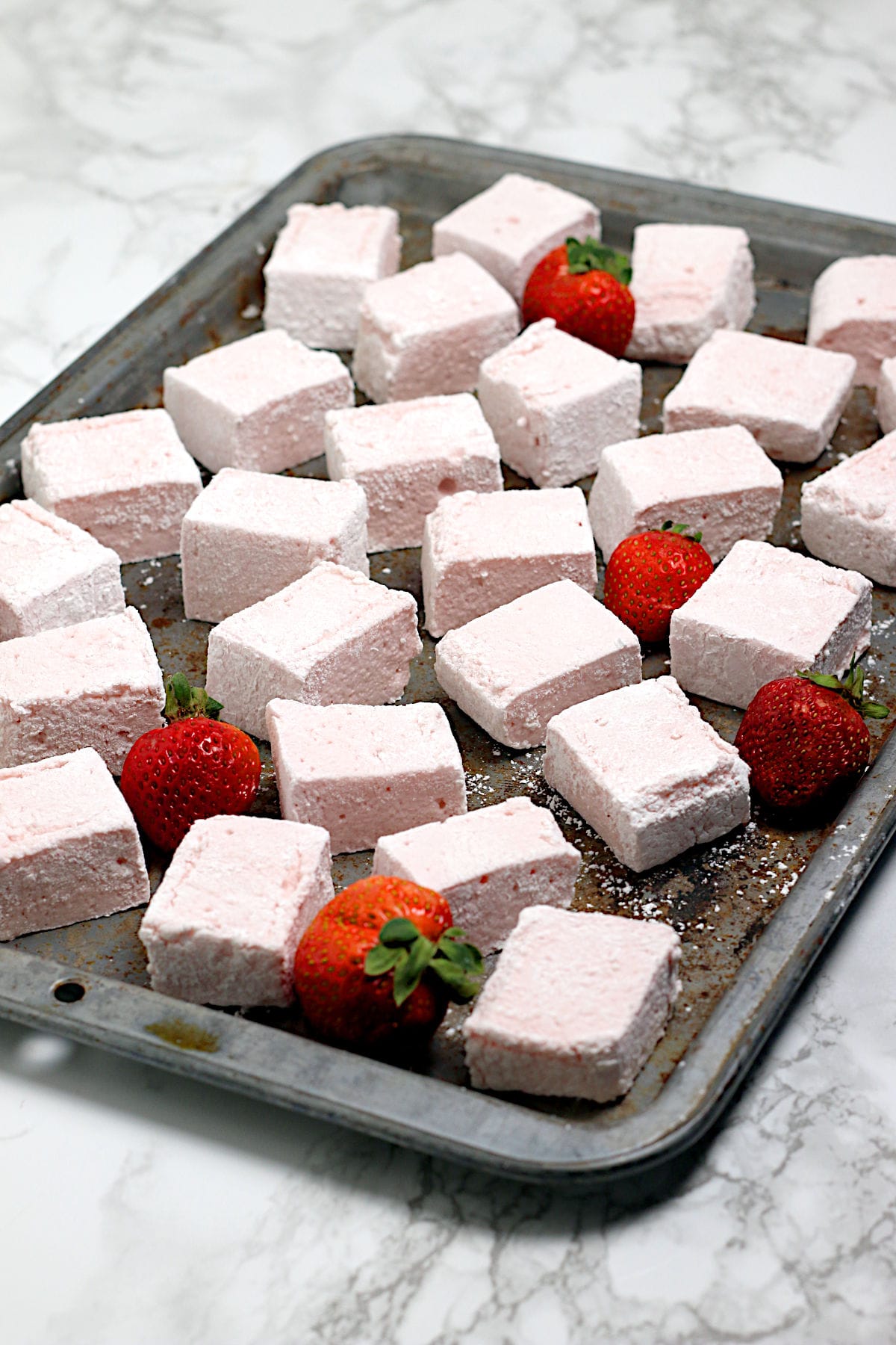 Homemade Strawberry Marshmallows on a baking sheet.