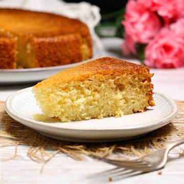A slice of honey rose cake on a small white plate.