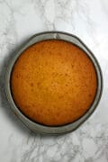 A honey rose cake in a round cake pan.