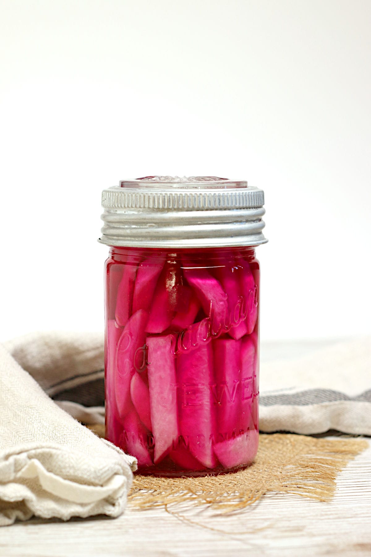 Pink pickled turnips in a jar.