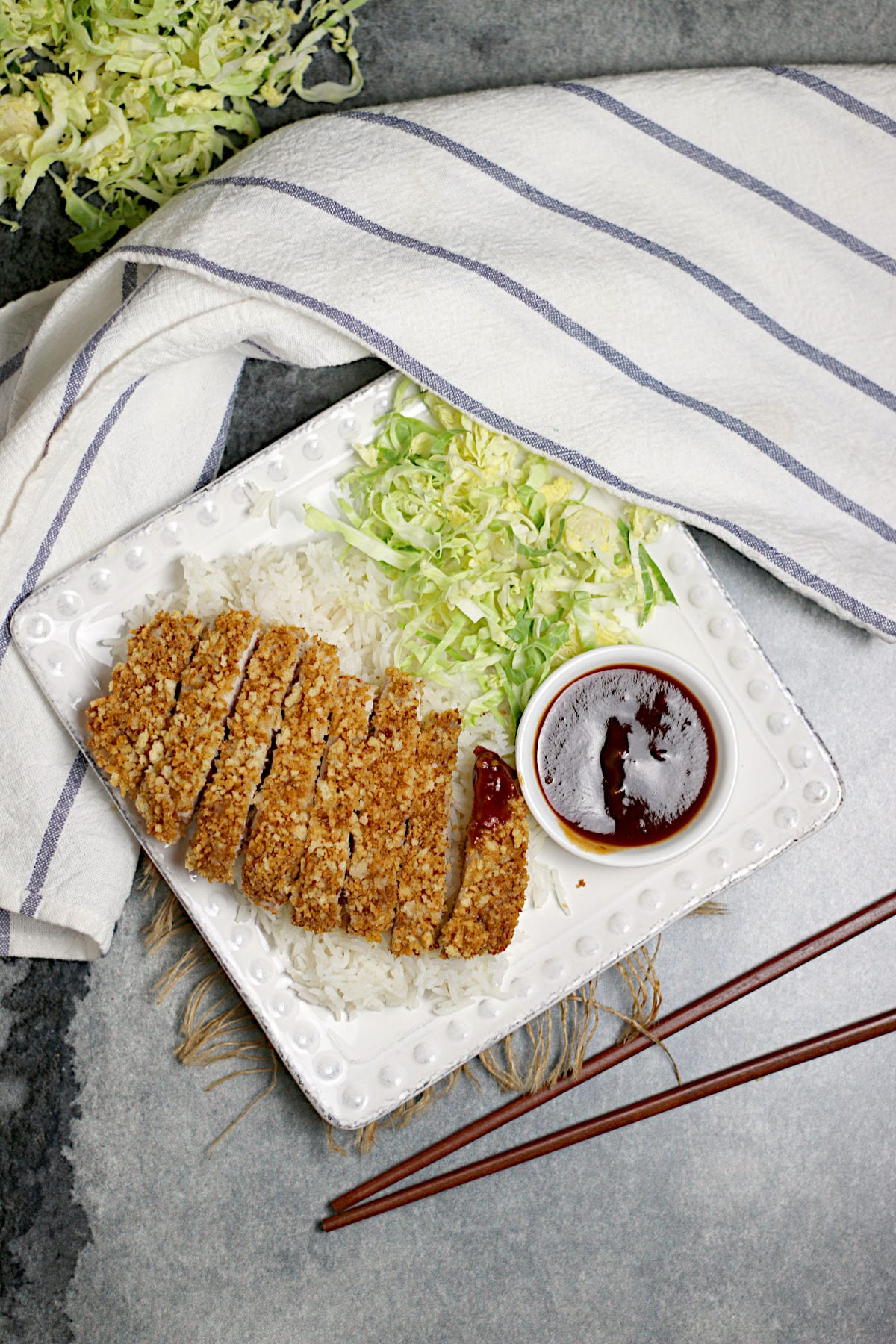 An overhead photo of sliced Air-Fryer Tonkatsu on a bed of white rice.