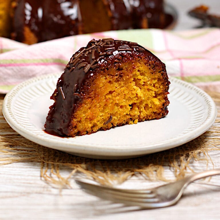 A slice of Brazilian Carrot Cake on a small white plate.