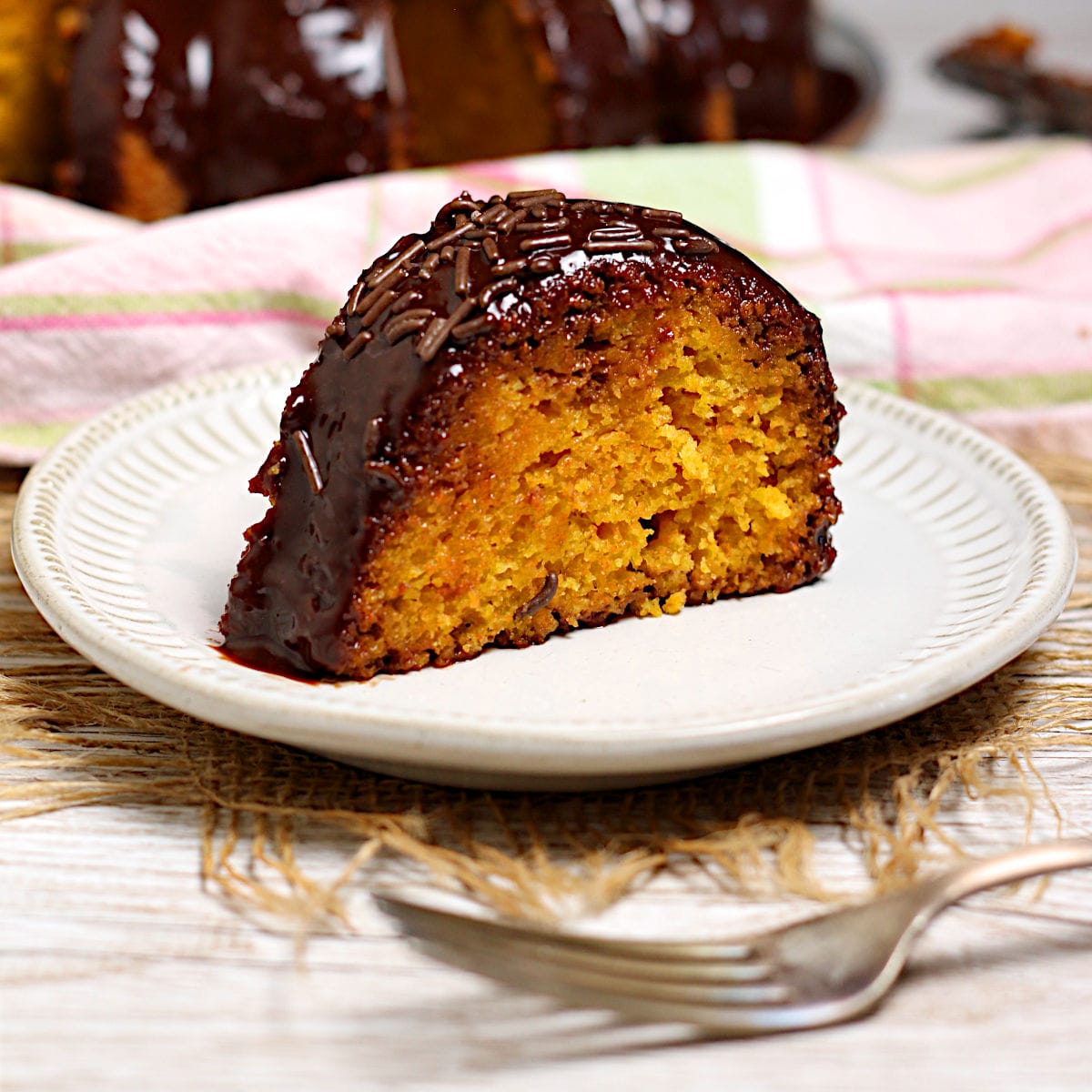 A slice of Brazilian Carrot Cake on a small white plate.