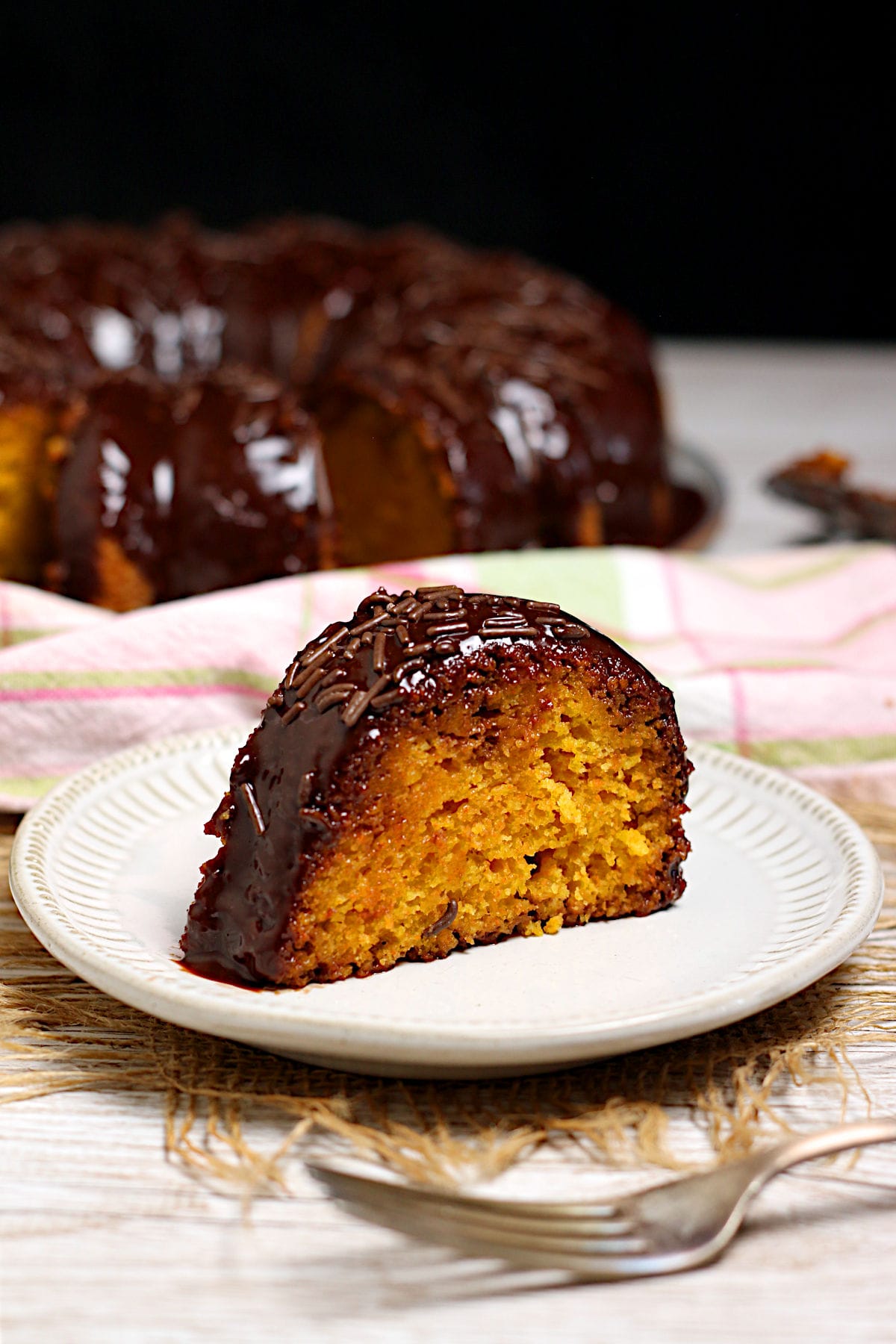 A slice of Brazilian Carrot Cake on a small white plate.