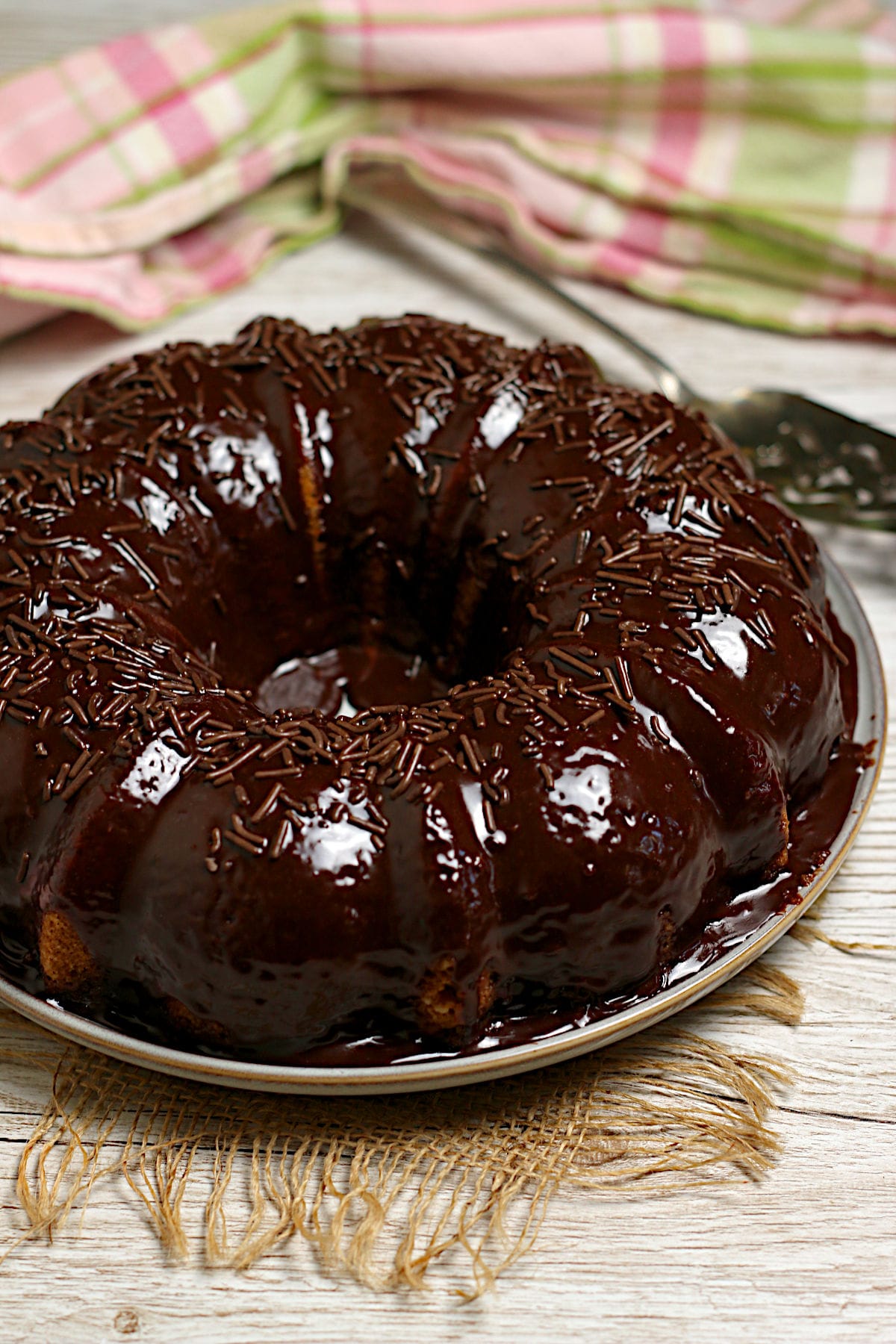 A whole Brazilian Carrot Cake with fudgy chocolate frosting and chocolate sprinkles.