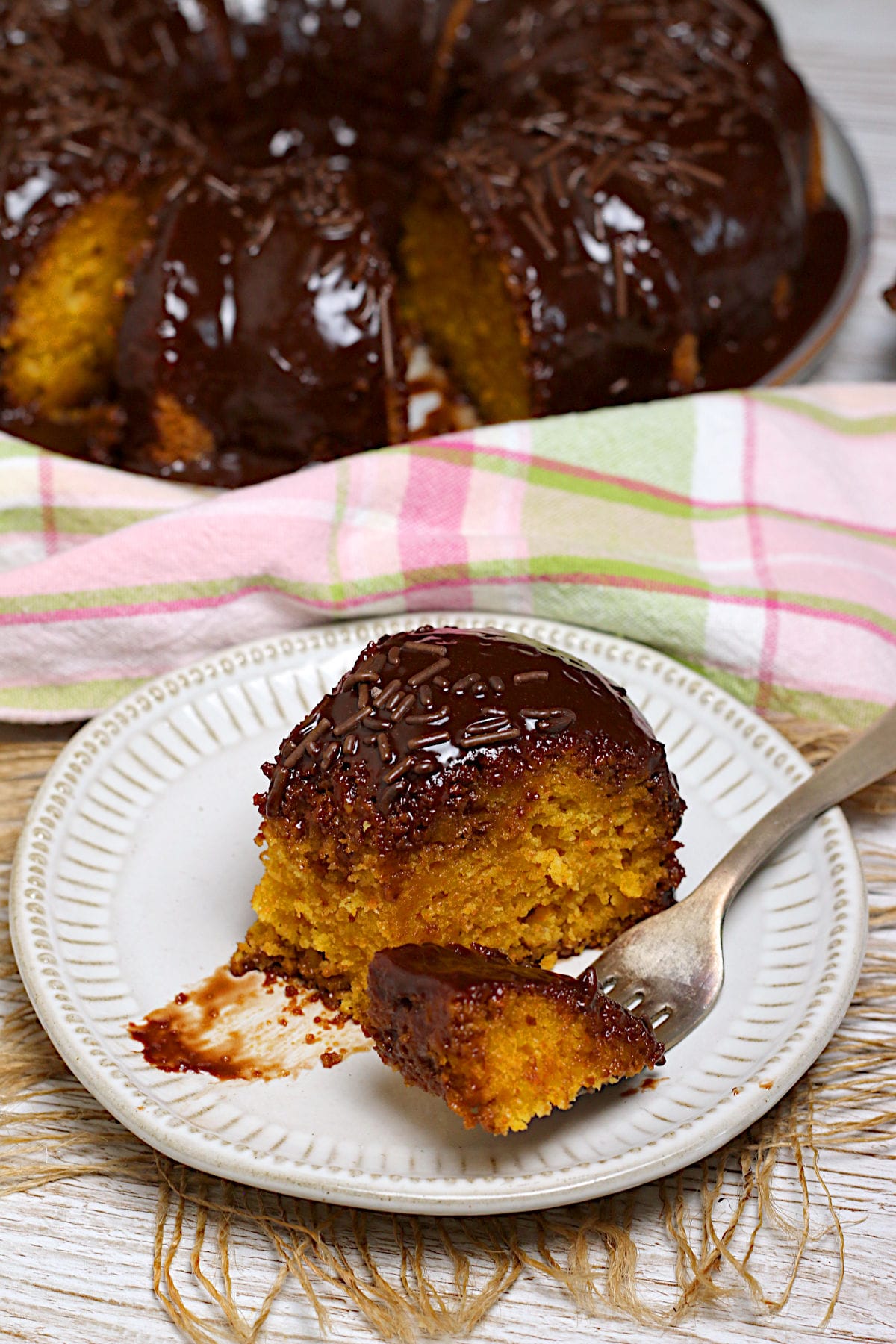 A slice of Brazilian Carrot Cake on a small white plate.