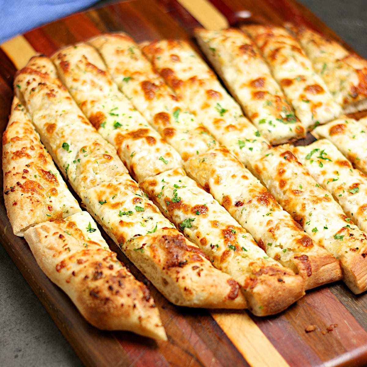 Nova Scotia Garlic Fingers on a wood cutting board.