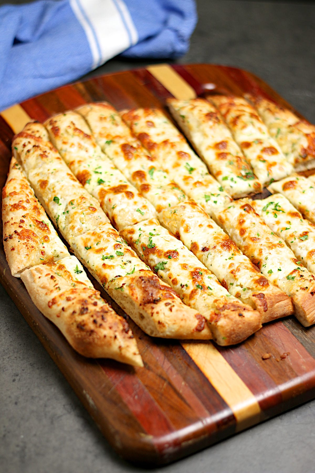 Nova Scotia Garlic Fingers on a wood cutting board.