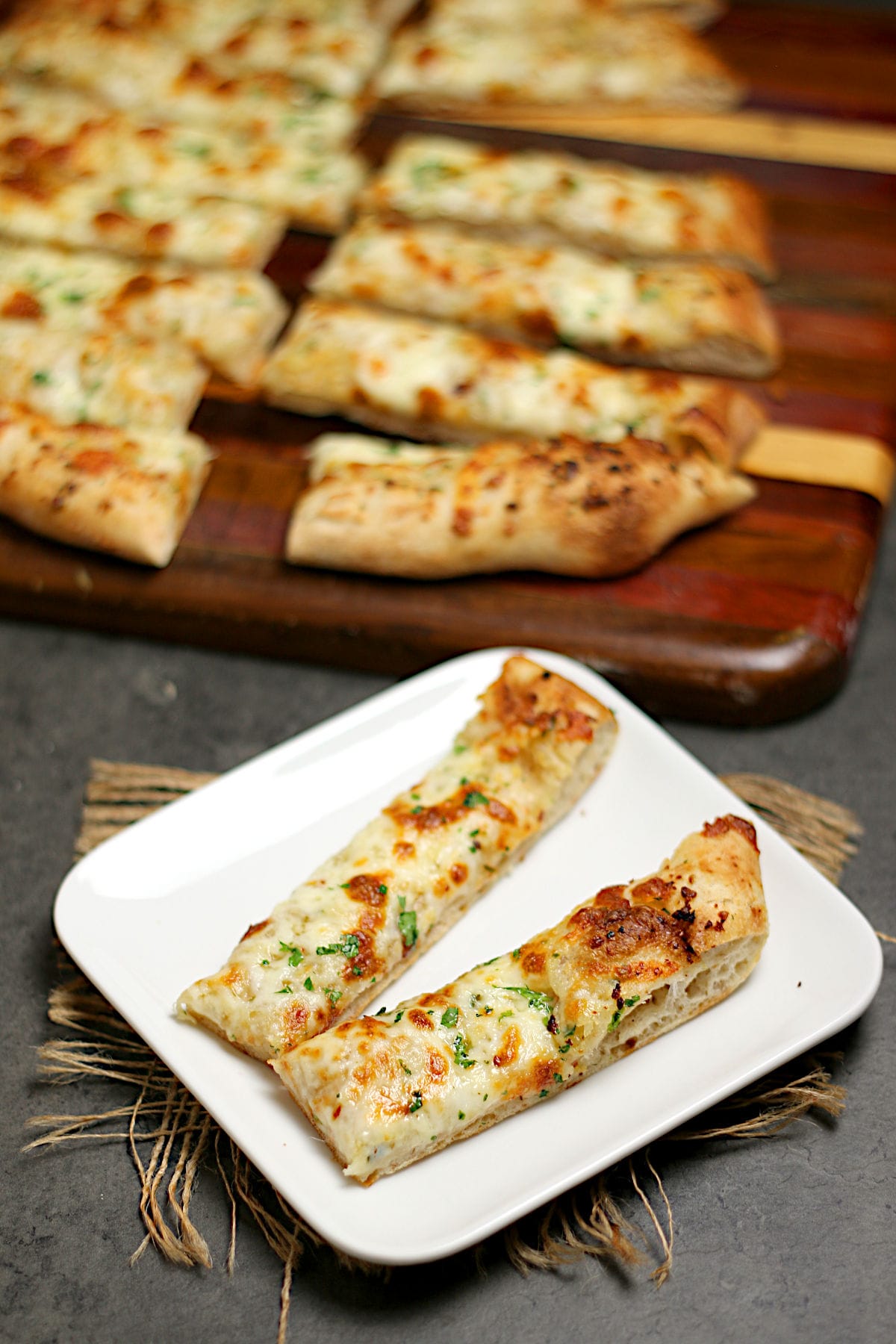 Two Nova Scotia Garlic Fingers on a small white plate.
