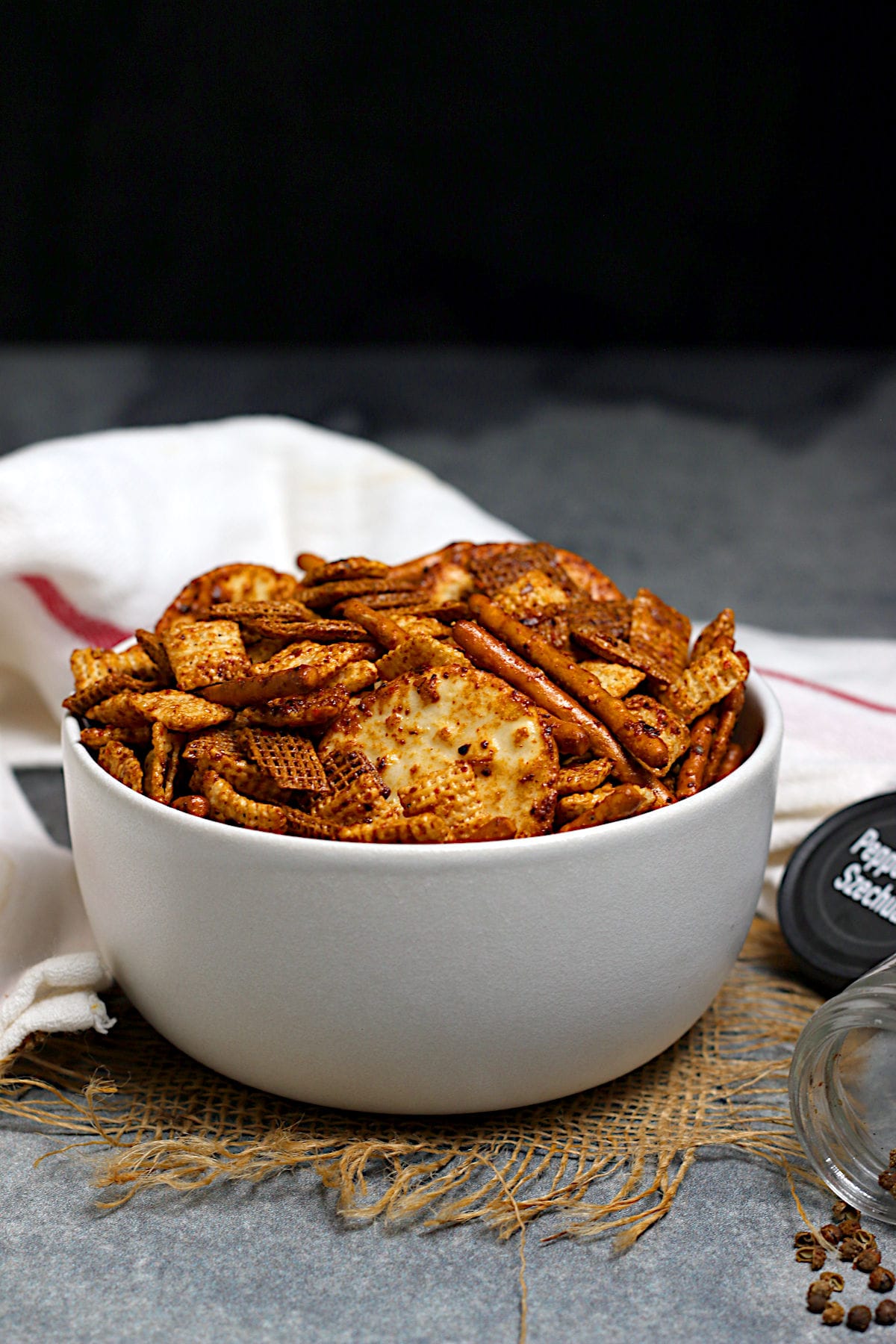 Spicy Sichuan Chex Mix in a white bowl.