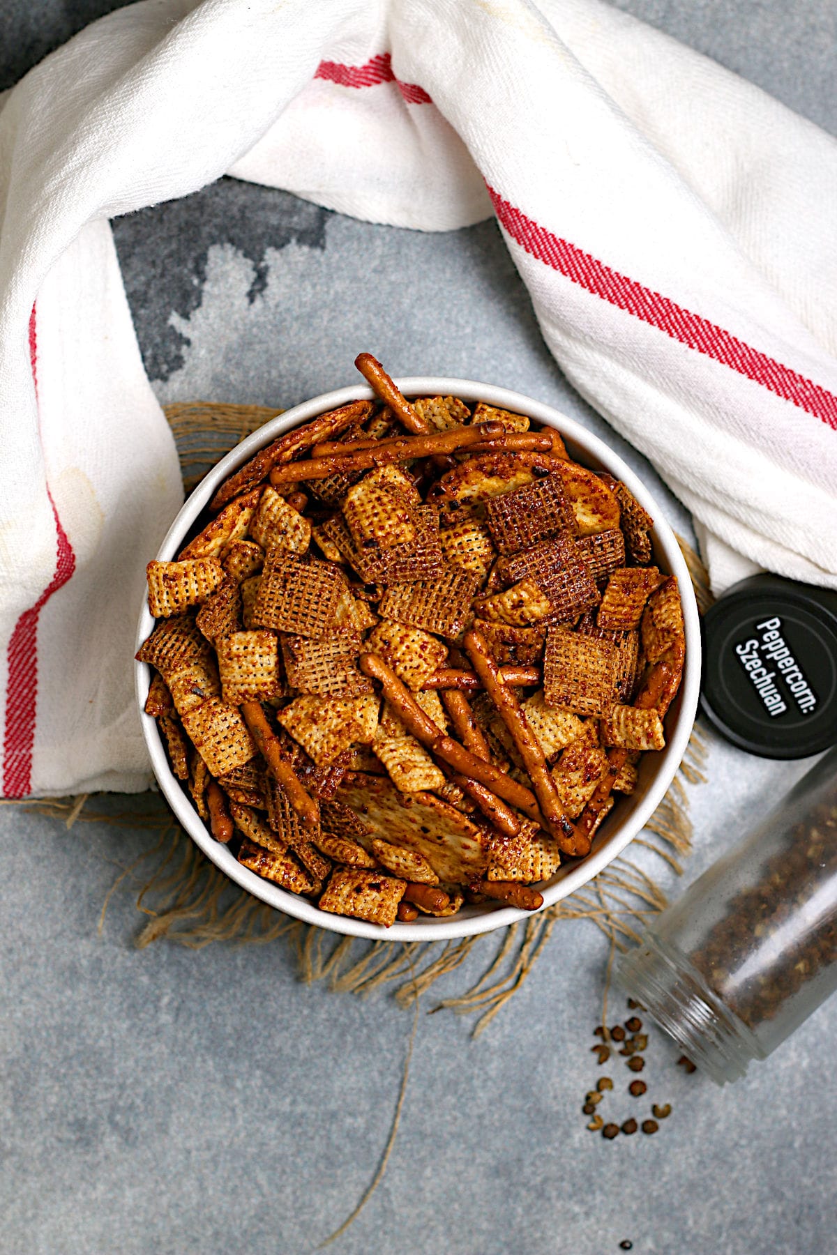 An overhead photo of Spicy Sichuan Chex Mix in a white bowl.