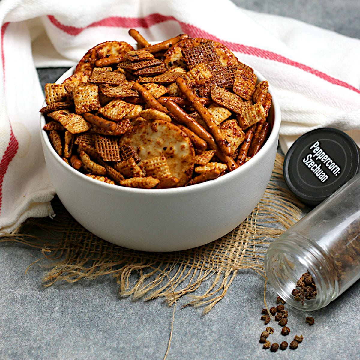 Spicy Sichuan Chex Mix in a white bowl.