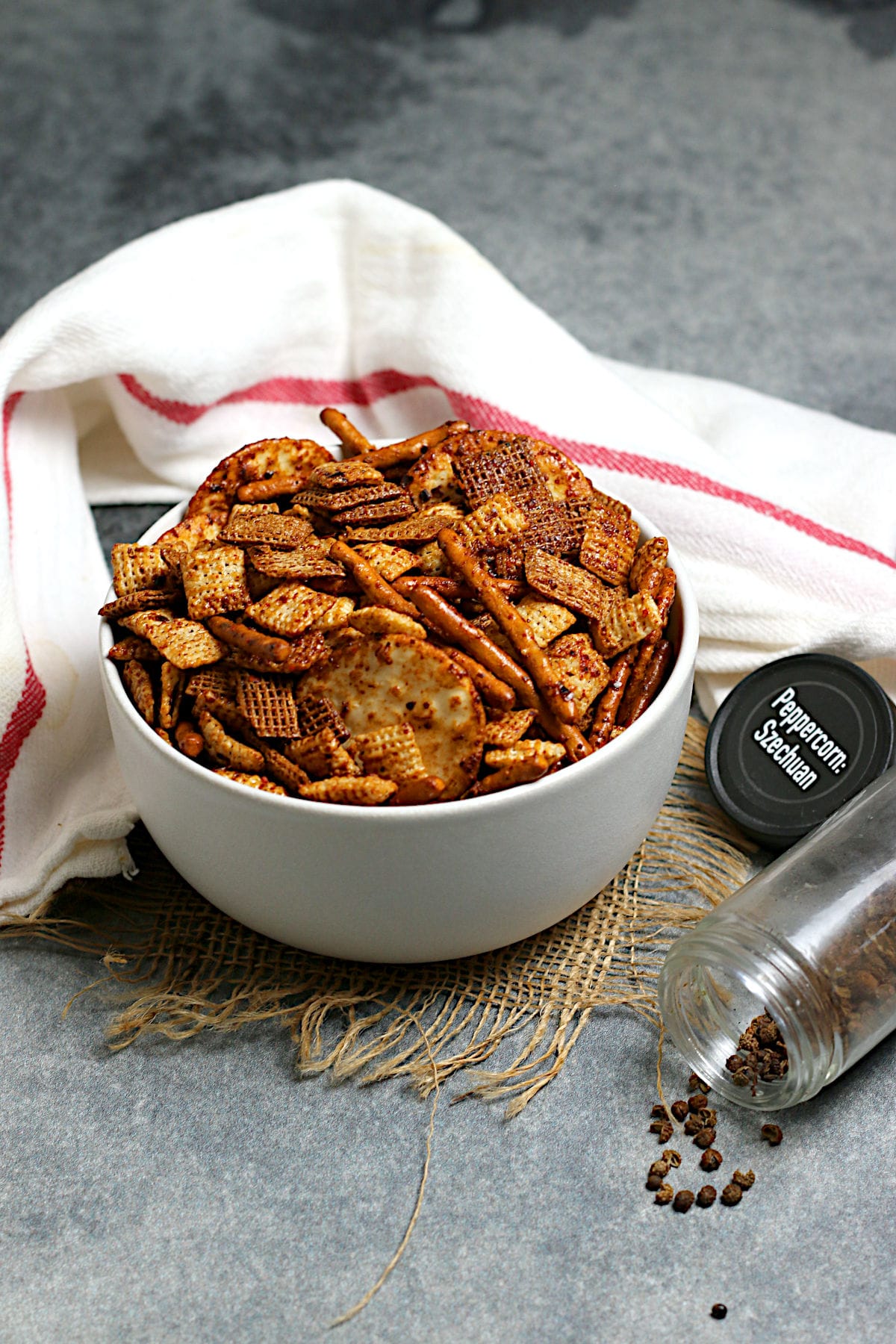 Spicy Sichuan Chex Mix in a white bowl.