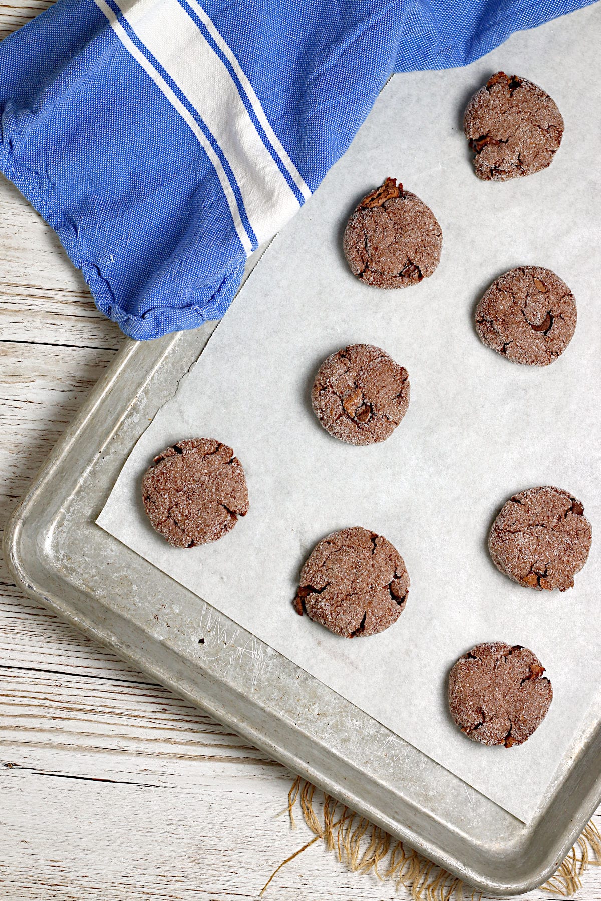 An overhead photo of Vegan Double Chocolate Cookies on a parchment-lined baking sheet.