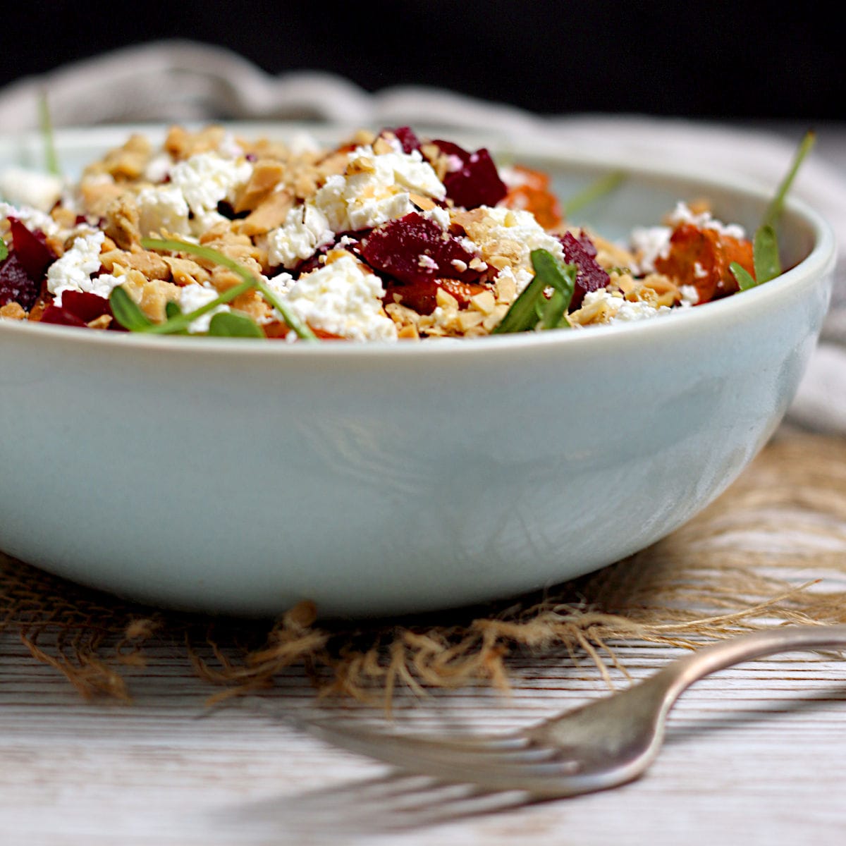 Arugula Salad with Root Vegetables and Lentils in a pale blue bowl.